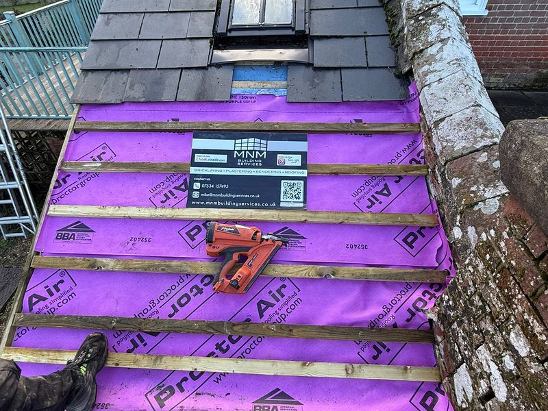 Slate roof being laid over breather membrane — MNM Building Services, Dorset